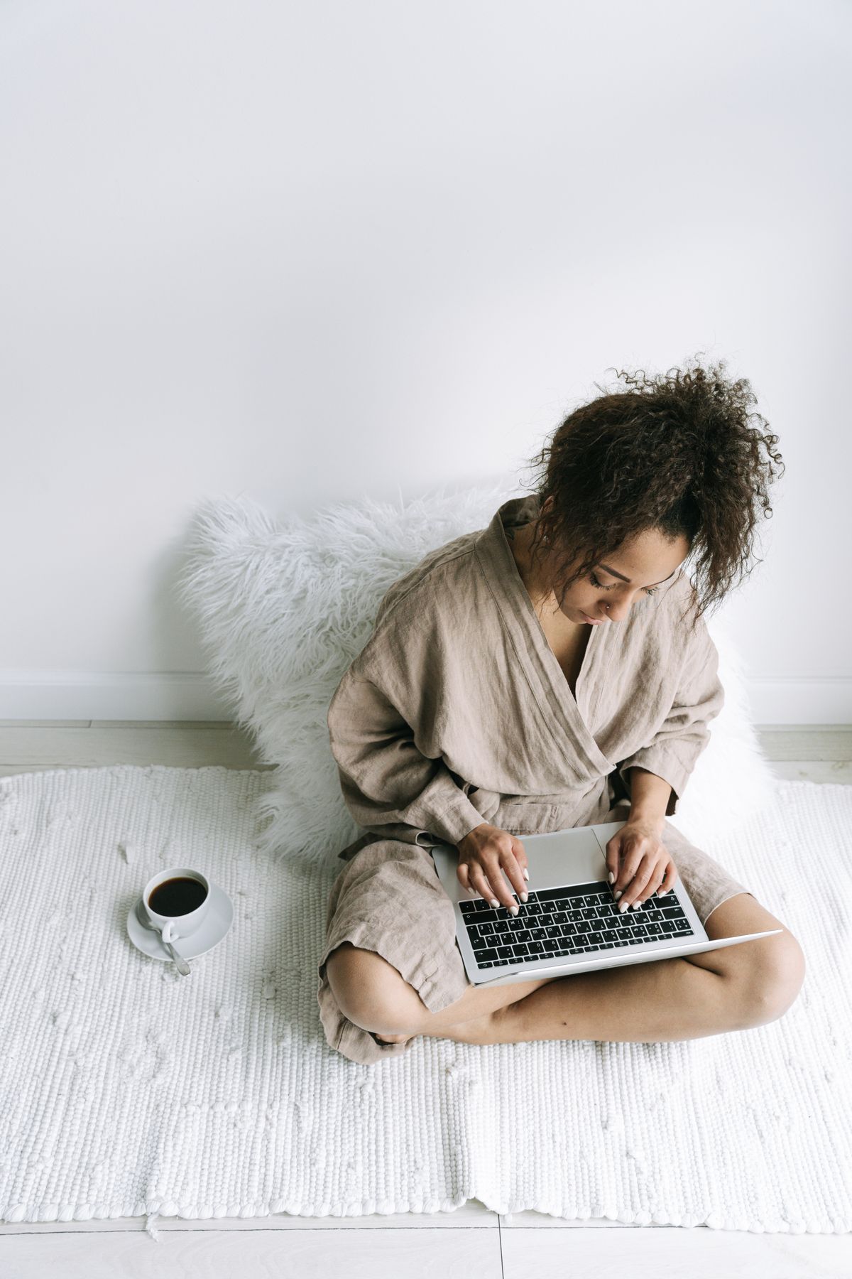 Woman in a robe relaxing at home with her laptop